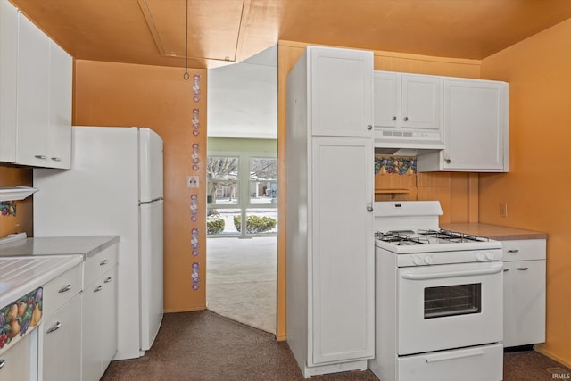 kitchen featuring white cabinetry, white appliances, and carpet floors