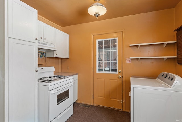 kitchen with white gas range, washing machine and dryer, and white cabinets