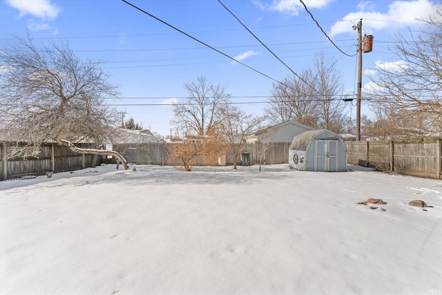 snowy yard with a shed