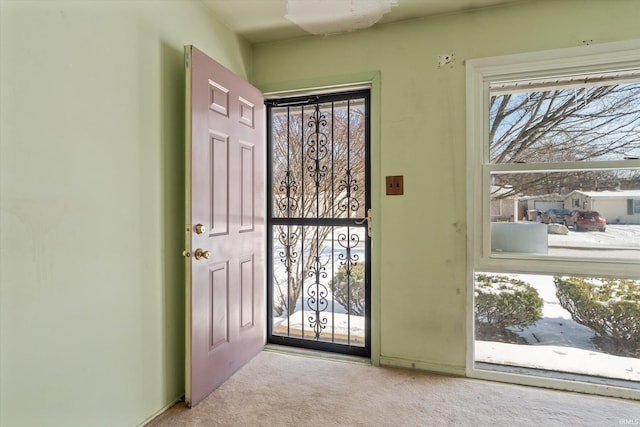 doorway featuring light carpet