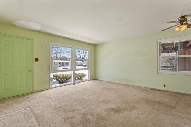 interior space with light colored carpet and ceiling fan