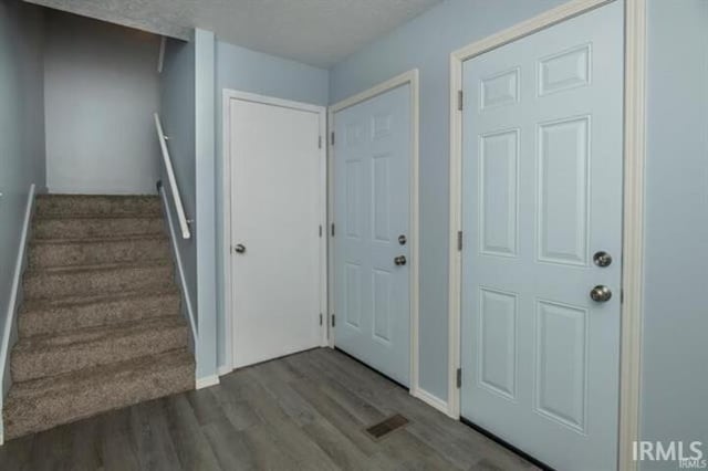 entryway with dark hardwood / wood-style flooring