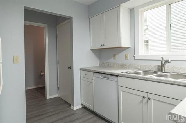 kitchen with sink, a wealth of natural light, white cabinets, and white dishwasher