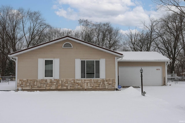 view of snow covered exterior featuring a garage