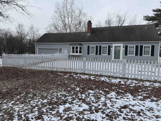 snow covered house with a garage