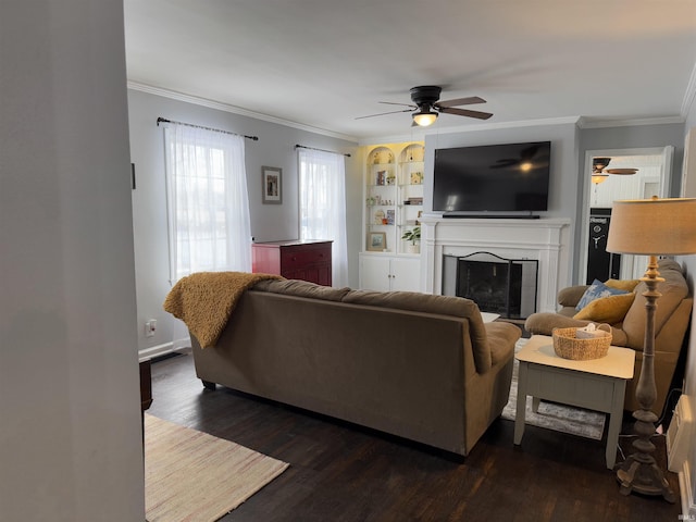 living room featuring dark hardwood / wood-style flooring, crown molding, built in features, and ceiling fan