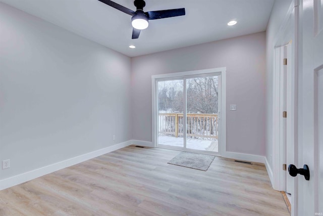 empty room featuring ceiling fan and light hardwood / wood-style flooring