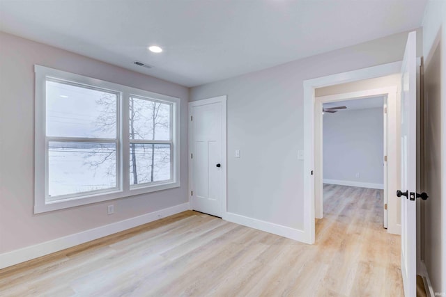 unfurnished room with light hardwood / wood-style flooring