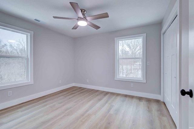 spare room featuring light hardwood / wood-style flooring and ceiling fan