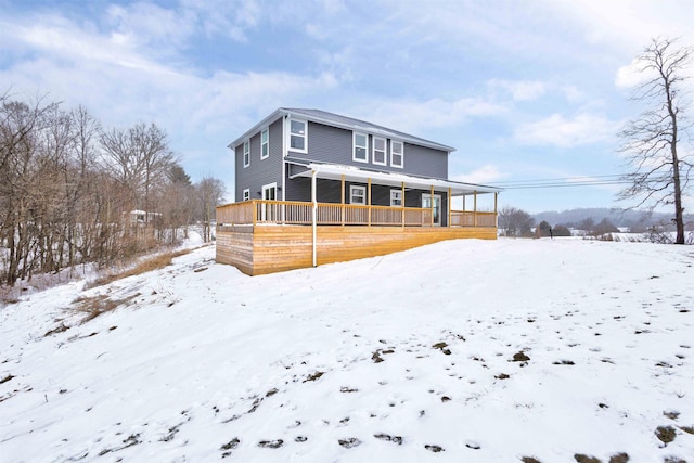 snow covered house featuring covered porch