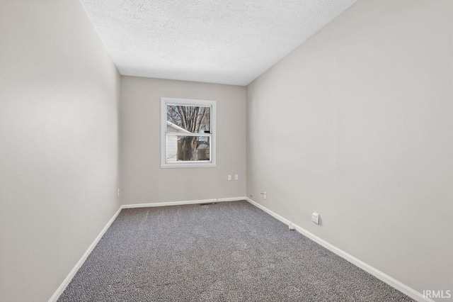 spare room with carpet floors and a textured ceiling