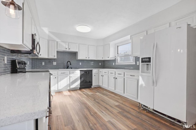 kitchen featuring white cabinetry, backsplash, and stainless steel appliances