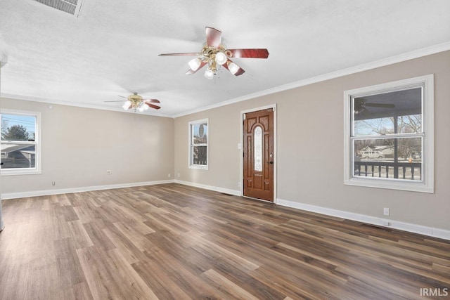 interior space with ornamental molding, ceiling fan, a textured ceiling, and dark hardwood / wood-style flooring