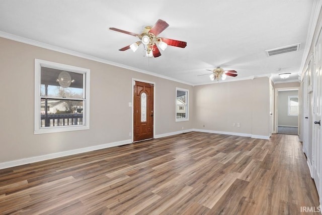 unfurnished living room with dark wood-type flooring, ornamental molding, and ceiling fan