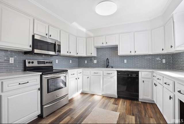 kitchen with white cabinetry, appliances with stainless steel finishes, and decorative backsplash