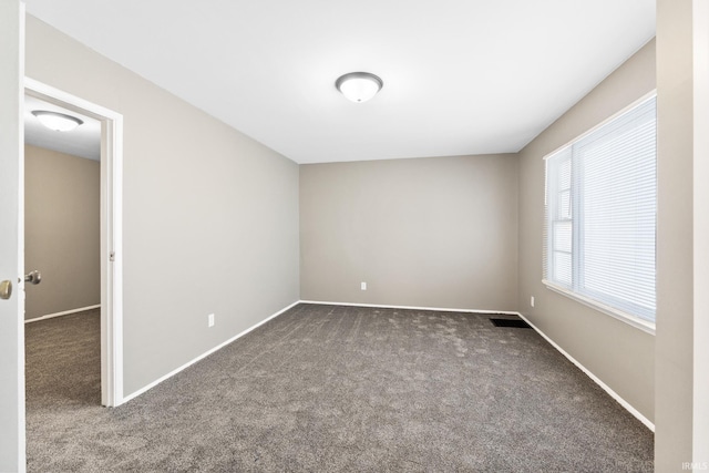 empty room with dark colored carpet