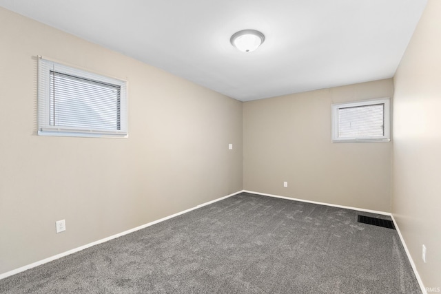 empty room with dark carpet