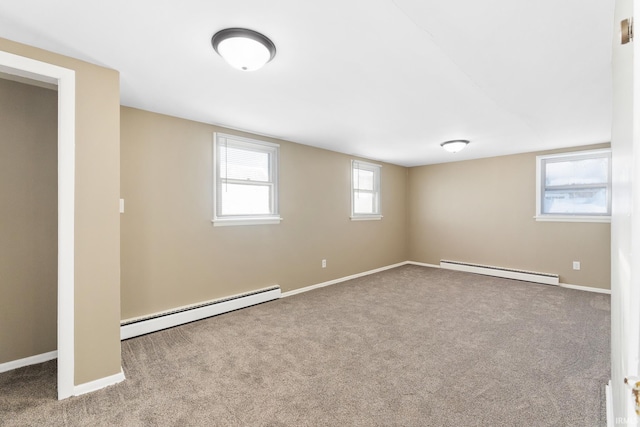 basement featuring a baseboard radiator and carpet