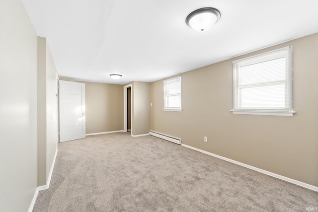 carpeted empty room with baseboard heating