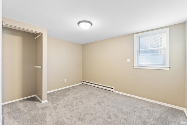 unfurnished bedroom with light carpet, a closet, and baseboard heating