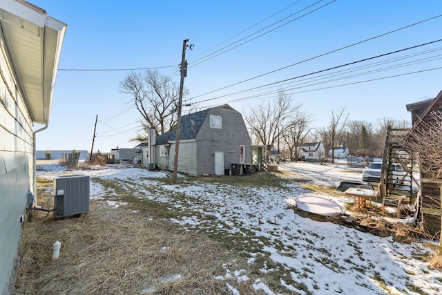 yard layered in snow featuring cooling unit