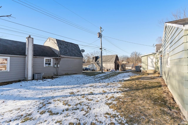 yard covered in snow featuring central air condition unit