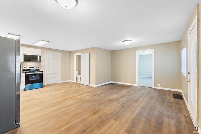 unfurnished living room featuring light wood-type flooring