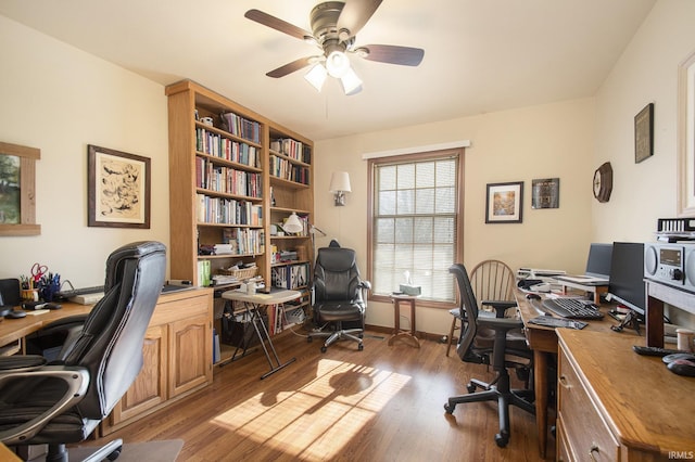 home office with hardwood / wood-style floors and ceiling fan