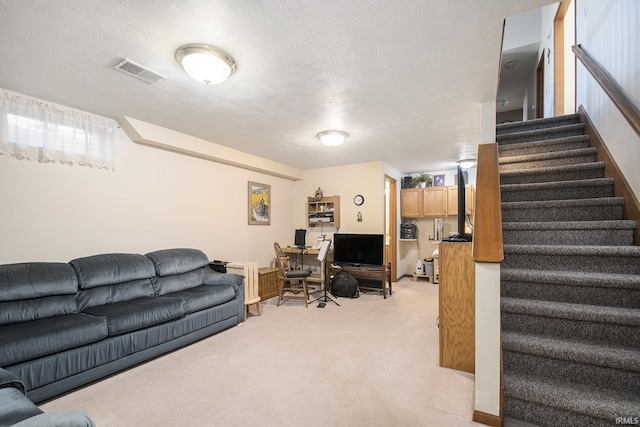 living room featuring light colored carpet and a textured ceiling