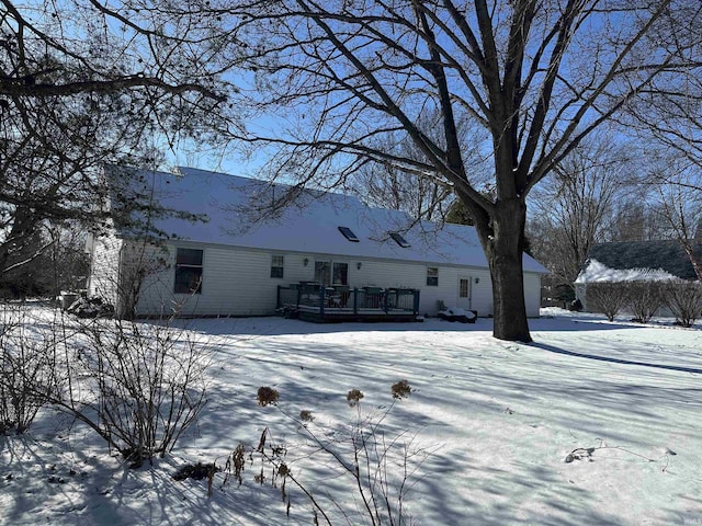 snow covered property featuring a deck