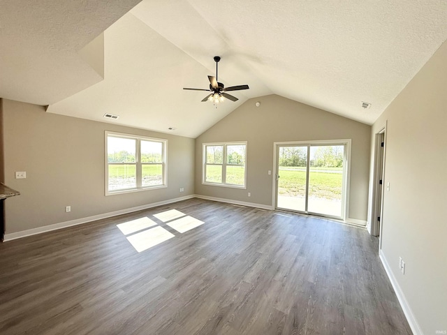 2360 Serenity Ct, Auburn, IN 46706 - unfurnished living room featuring ceiling fan, dark wood finished floors, lofted ceiling, baseboards, and a textured ceiling