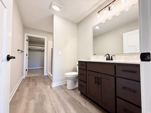 2360 Serenity Ct, Auburn, IN 46706 - full bath featuring wood finished floors, a stall shower, toilet, vanity, and baseboards