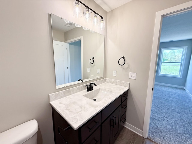 2360 Serenity Ct, Auburn, IN 46706 - bathroom featuring toilet, vanity, and baseboards