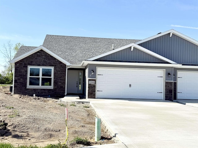 2360 Serenity Ct, Auburn, IN 46706 - view of front facade with stone siding, concrete driveway, and an attached garage