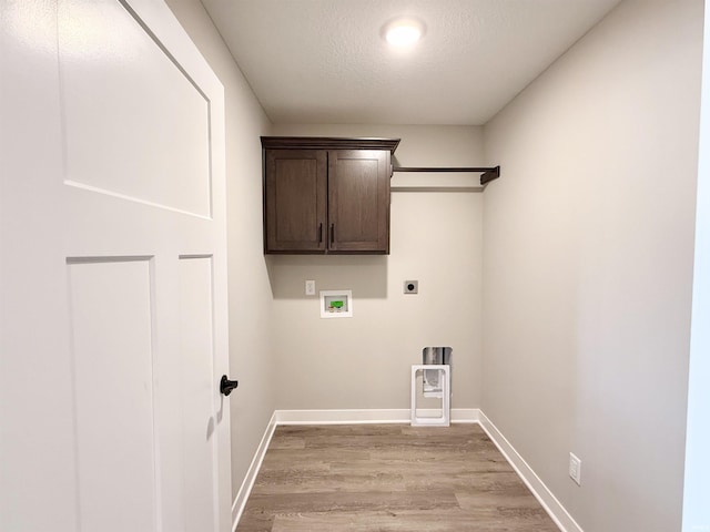 2360 Serenity Ct, Auburn, IN 46706 - clothes washing area featuring hookup for an electric dryer, light wood-style flooring, hookup for a washing machine, baseboards, and a textured ceiling