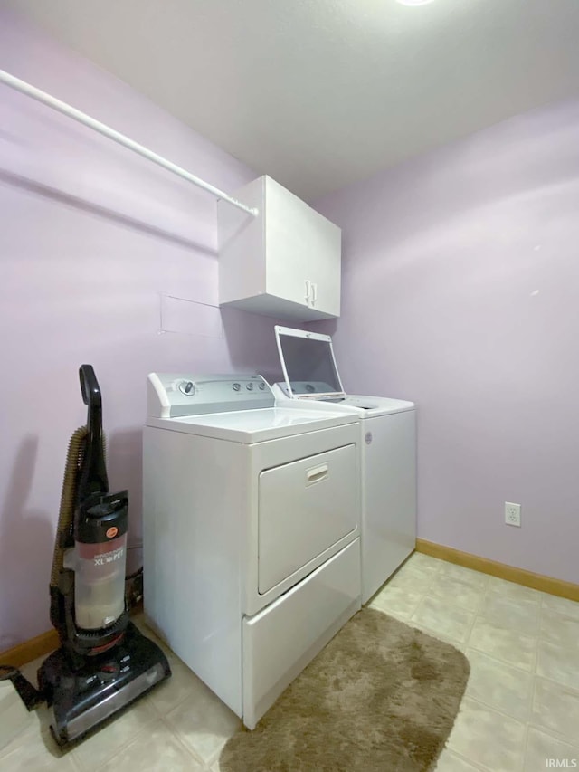 washroom featuring cabinets and washing machine and clothes dryer