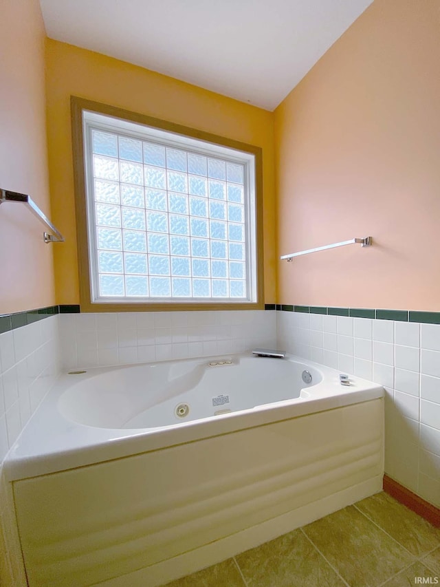 bathroom featuring tile patterned floors and a tub to relax in