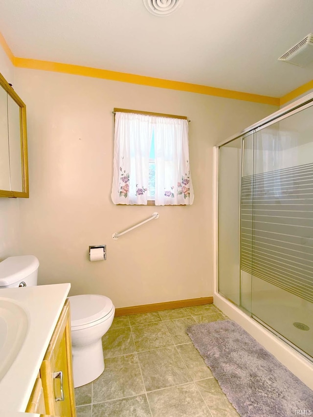 bathroom with vanity, crown molding, toilet, and walk in shower