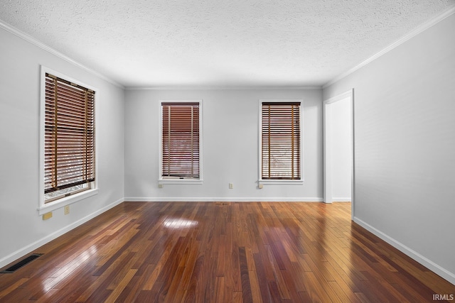 spare room featuring ornamental molding, a textured ceiling, and dark hardwood / wood-style flooring