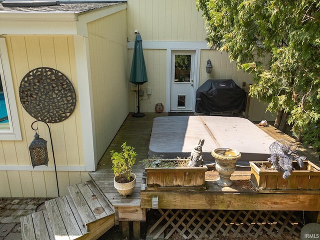 wooden deck with a grill