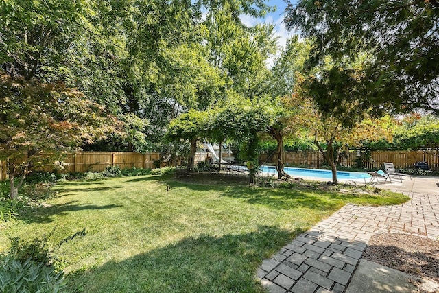 view of yard with a fenced in pool and a patio area