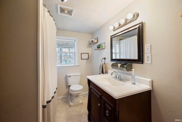 bathroom featuring vanity and toilet