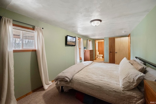 carpeted bedroom with ensuite bath