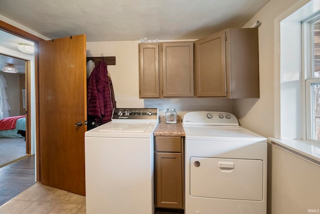 washroom with cabinets and independent washer and dryer