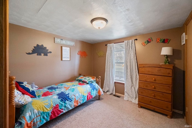 carpeted bedroom with a textured ceiling