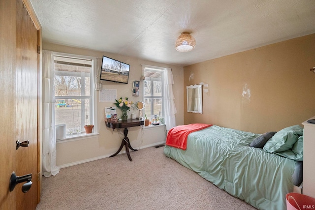 carpeted bedroom with multiple windows and a textured ceiling