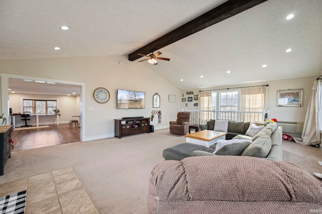 carpeted living room with ceiling fan, lofted ceiling with beams, and a textured ceiling