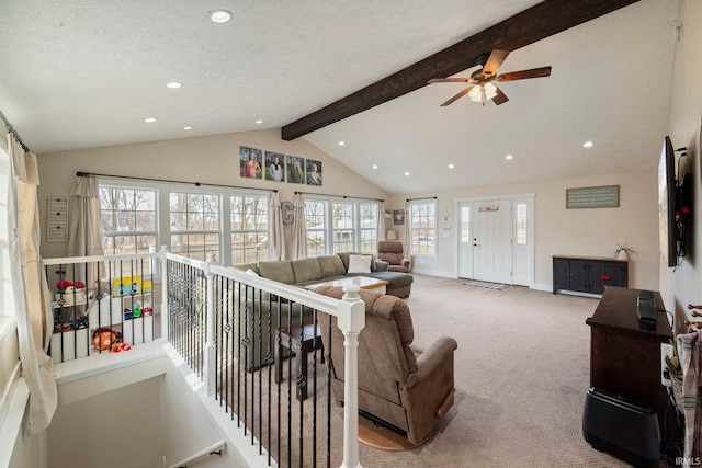 carpeted living room with lofted ceiling with beams and a textured ceiling