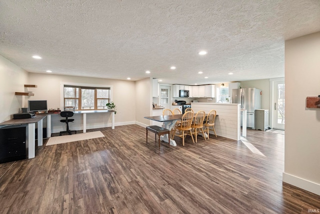 dining space featuring hardwood / wood-style flooring and a textured ceiling