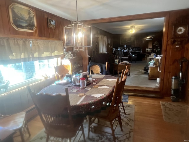 dining area featuring wooden walls and hardwood / wood-style floors